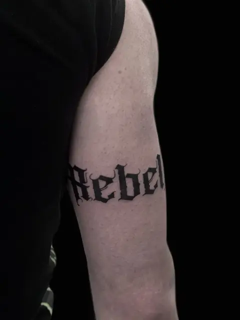 Schriftzug im gotischen Stil am Oberarm, Black & Grey